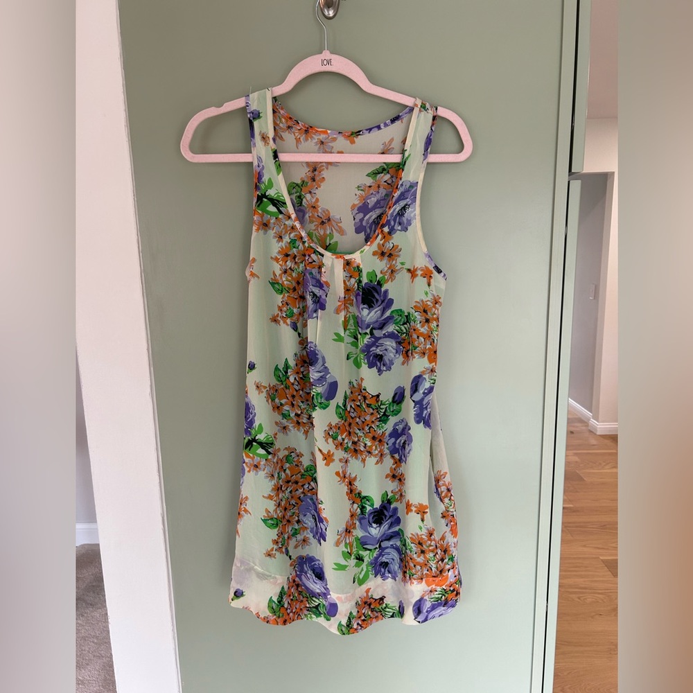 Sheer orange and purple floral mini dress with bright green slip.